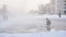 A man pours water over a winter skating rink, slow mo, stadium