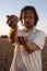 Man pours wheat grains from hand to hand at wheat field