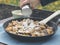 Man powdering kaiserschmarrn with sugar on alp