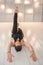 A man practices yoga in a bright studio. Man and yoga asanas with elastic