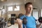 Man practicing bicep curls with dumbbells at a gym, close up