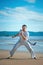 Man practicing capoeira on the beach. The man does the fighting element of capoeira.