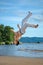 Man practicing capoeira on the beach. The man does the fighting element of capoeira.