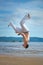 Man practicing capoeira on the beach. The man does the fighting element of capoeira.