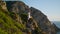 Man practicing yoga asana at stunning ocean cliff view. Focused athlete exercise