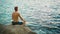 Man practicing yoga on the seashore