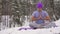 Man practicing yoga in the woods in nature in winter