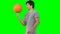 A man practises spinning a basketball on his finger