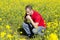 Man praying alone in a field of flowers.