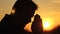 a man praying with his hands at sunset, a silhouette of a man asking for help and forgiveness from the sky, happy days