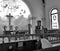 Man Praying inside a Religious Church with Beautiful Stained Glass and Cross