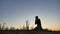 Man praying kneeling reads a praying believes in god. faith concept. Man kneeling silhouette while hill nature sunset