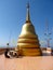 A man praying near Golden stupa in a Buddhist Temple in Thailand