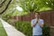 Man praying outside along a pathway.