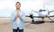 Man praying over airplane on runway background