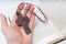 Man is praying. Prayer\'s hand holds crucifix. Bible in background