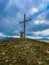 A man prays on a mountain in front of a cross-beautiful wallpaper