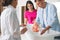 Man with pregnant wife learning how to bathe baby at courses for expectant parents indoors