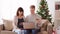 Man and pregnant wife shopping online at christmas