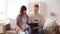 Man and pregnant wife shopping online at home