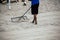 The man prepares a beach volleyball court using the rake