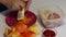 A man prepares bell peppers stuffed with minced meat and rice. Chops carrots on a grater