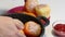 A man prepares bell peppers stuffed with minced meat and rice. Places it in a cooking pot