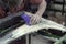 A man prepares a car body element for painting after an accident