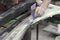 A man prepares a car body element for painting after an accident