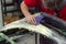 A man prepares a car body element for painting after an accident