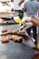 Man prepares fried meat on street food festival