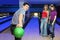 Man prepares throw ball and girl look on him