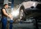 Man preparing for adjusting tire wheel at repair garage