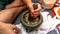 Man preparing a cooking ingredients by using mortar and pestle at the kitchen