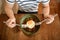 Man preparing for eating a rice with marinated chili pork and fried egg in ceramic bowl