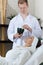 Man preparing facial mask for female client at beauty salon