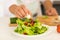 Man preparing green salad