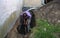 Man preparing hole in ground for Installation of new studded film as insulation against ground moisture