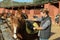 Man preparing horse for walk - putting on saddle and bridle