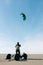 Man preparing to ride kite-buggy on the beach.