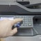 man presses buttons on the copier. office work business
