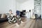 Man in Prisoner Uniform at Home Sitting on Floor and Reading a Book. Lockdown Concept