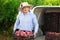 Man professional horticulturist packing crates with tasty peaches to car