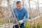 Man professional horticulturist working with wooden girders