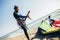 Man professional surfer standing on the sandy beach with his kite