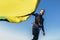 Man professional surfer standing on the sandy beach with his kite