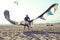 Man professional surfer standing in wetsuit with his kite