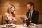 Man proposes to a woman over a romantic dinner