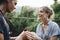 Man proposing to his happy girlfriend outdoors love and marriage concept