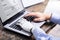 Man With Prosthetic Hand Working On Laptop